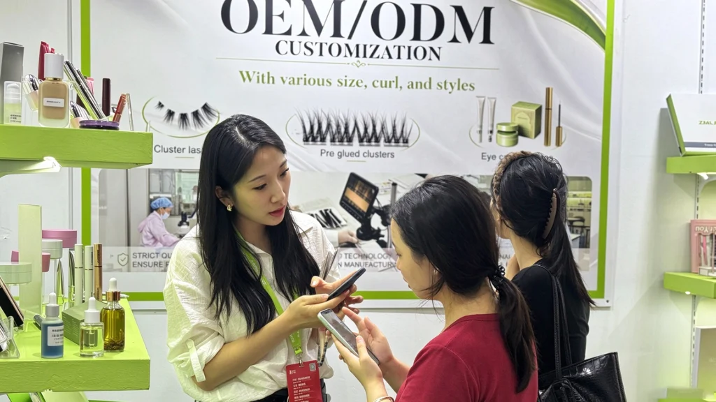 ZM Cosmetic Lab representative discussing OEM and ODM makeup customization with visitors at a cosmetics trade show booth